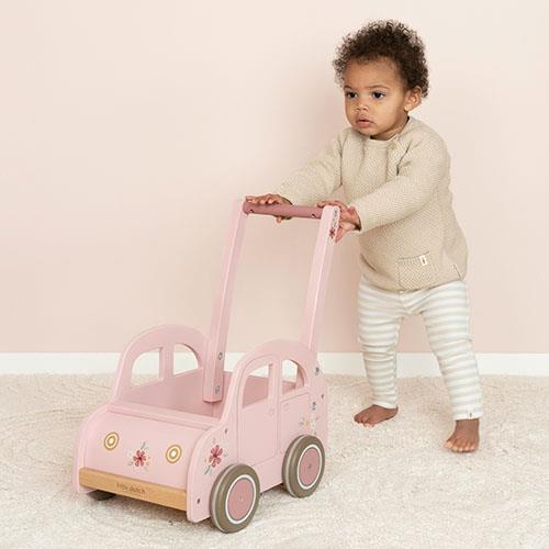 Little Dutch wooden push cart in vintage pink, used by a toddler to help with first steps and store toys.