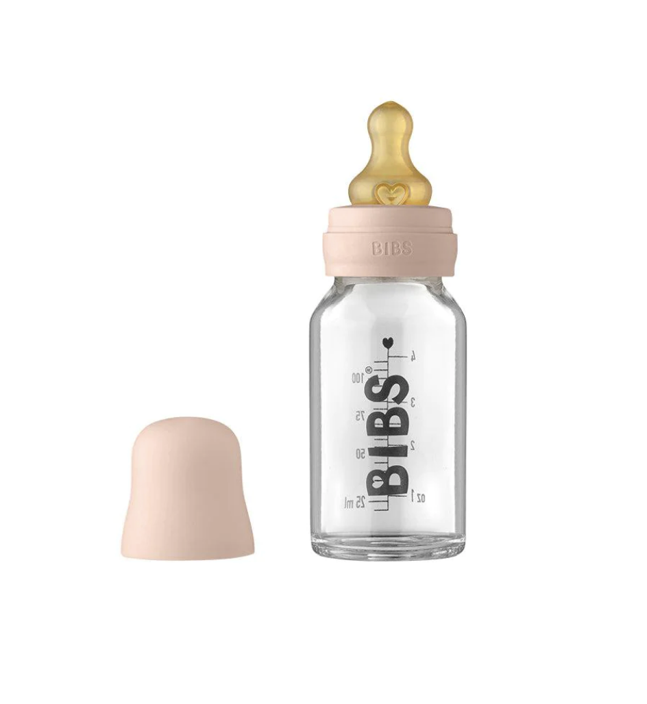 A close-up view of a BIBs glass baby bottle with a natural-shaped nipple and ergonomic design