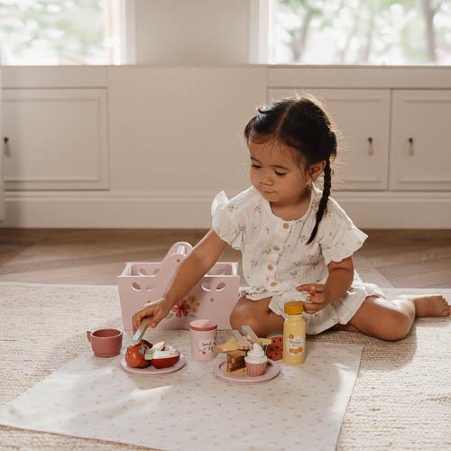 A complete wooden picnic play set by Little Dutch with plates, cutlery, and a picnic basket.